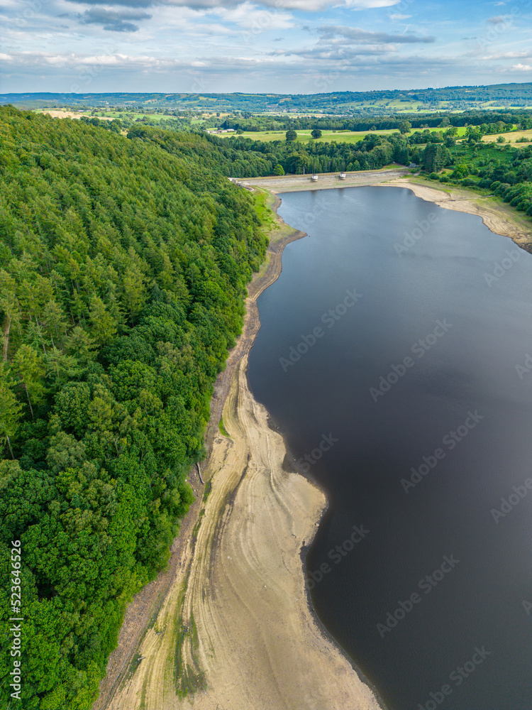 Aerial drone view of Lindley Wood Reservoir, North Yorkshire, showing the dry reservoir basin following heatwave & hot weather.