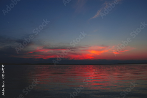 Sunset on the sea. Background image with clouds and reflection. © Алексей Свидерский