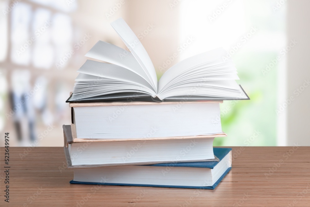 A simple composition of many books, stack or pile of books on wooden table concept A simple composition of many books, stack or pile of books on wooden table concept