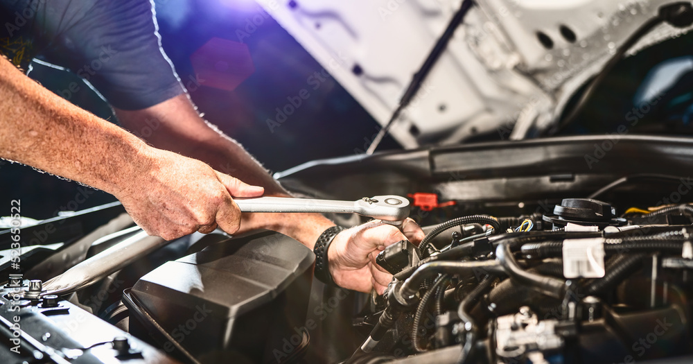 Auto mechanic working in garage. Repair service. Auto mechanic working in garage. Repair service.
