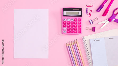 Back to school pastel pink background with school supplies and paper card copy space. Flat lay. Back to school concept