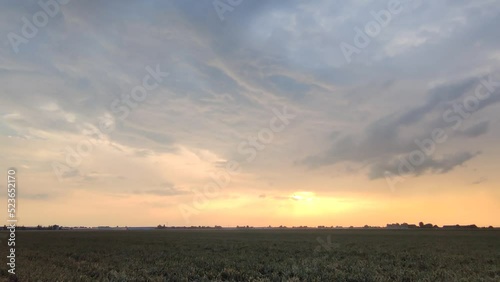 Panoramic footage of dramatic looking storm clouds over agricultural Dutch landscape on a summer evening.