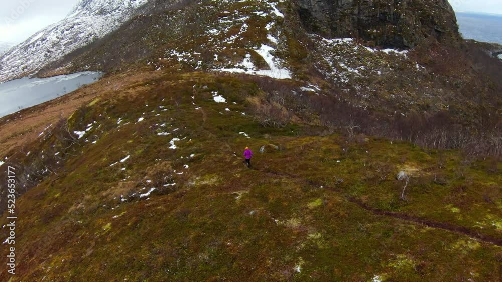 Woman Running On Natural Mountain Landscape During Winter - Tromso, Norway Woman Running On Natural Mountain Landscape During Winter - Tromso, Norway