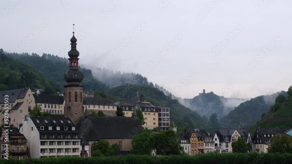 The church of Cochem, the Castle of Winneburg and the surrounding hills in the romantic Moselle River Valley. Fast motion of mysterious clouds and beautiful rising steam on a rainy summer morning. 4K The church of Cochem, the Castle of Winneburg and the surrounding hills in the romantic Moselle River Valley. Fast motion of mysterious clouds and beautiful rising steam on a rainy summer morning. 4K