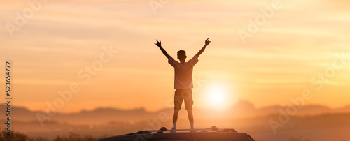 young men stand in cars and raise hands during sunset time. outdoor vacation and travel concept.