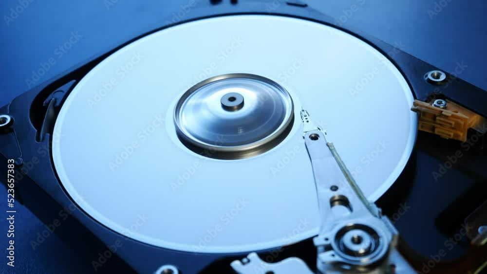 How the hard drive works inside, close up. Disassembled pc hdd on the blue background. Broken tightness of the hard drive. HDD repair, Data Recovery. How the hard drive works inside, close up. Disassembled pc hdd on the blue background. Broken tightness of the hard drive. HDD repair, Data Recovery.