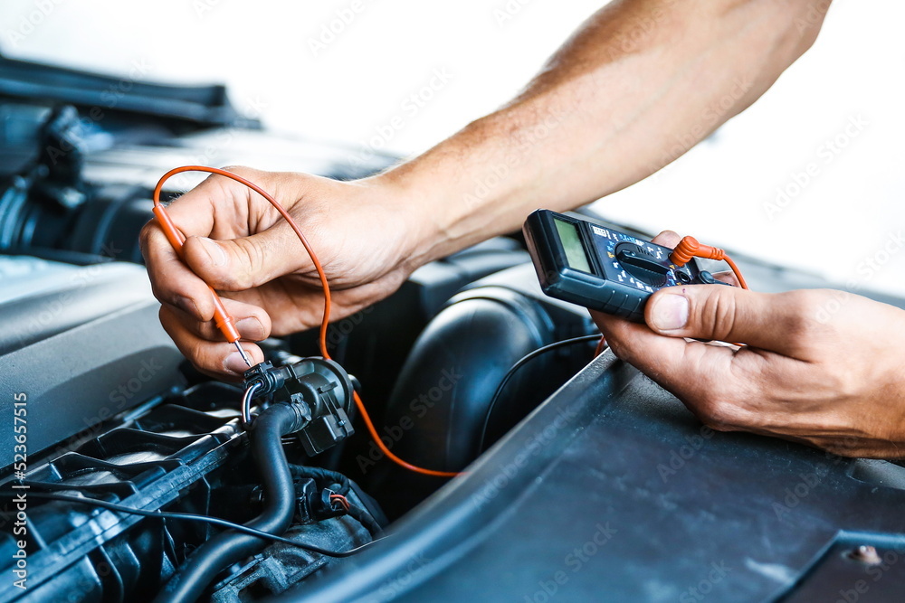 vehicle service concept photo. car engine wiring check. checking the sensors in the car motor. car electrician doing car diagnostics