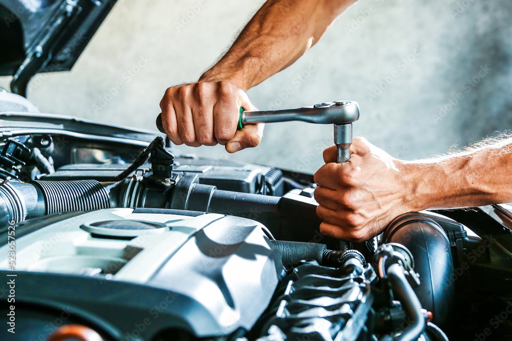car service concept photo. motor repairing close up. mechanic hands are repairing car engine car service concept photo. motor repairing close up. mechanic hands are repairing car engine