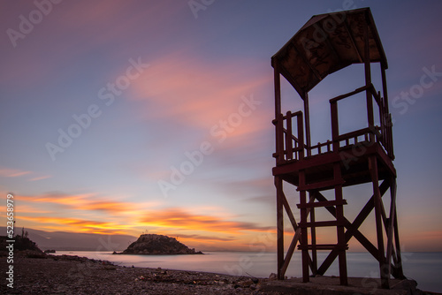 pireas greek sunrise long exposure rocks sand and island photo