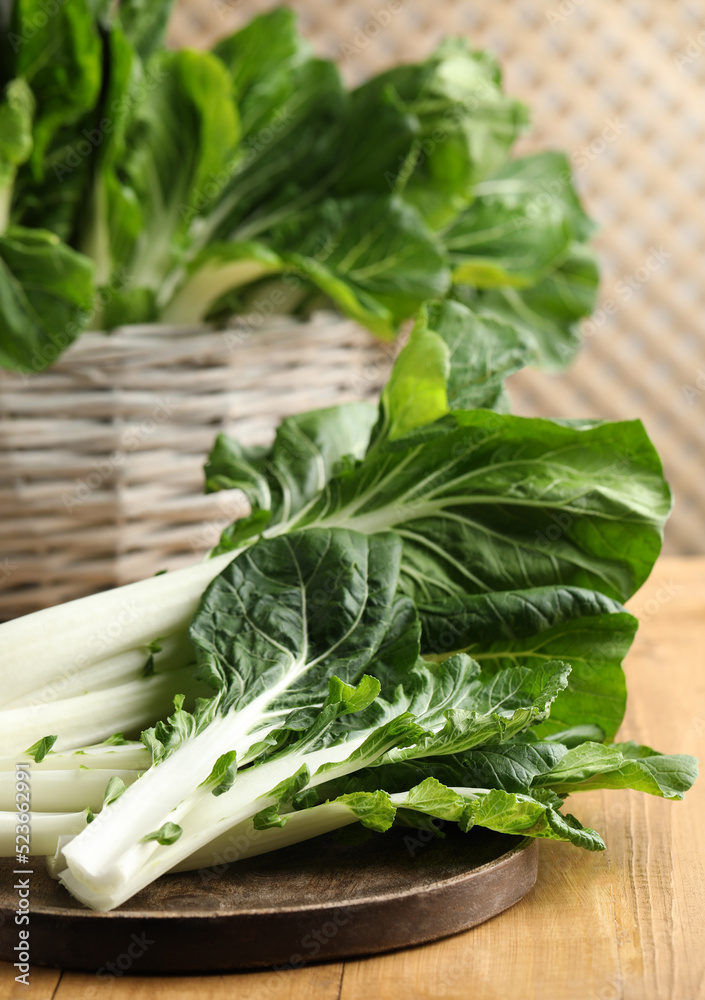 Leaves of fresh green pak choy cabbage on wooden table, closeup Leaves of fresh green pak choy cabbage on wooden table, closeup