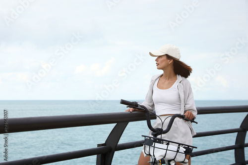 Wallpaper Mural Beautiful young woman with bicycle near sea. Space for text Torontodigital.ca