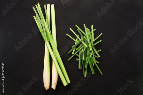 Fresh lemongrass with slice leaf on black background , top view , flat lay.