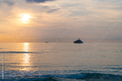sunset sky in summer vacation skyscape with ship on horizon