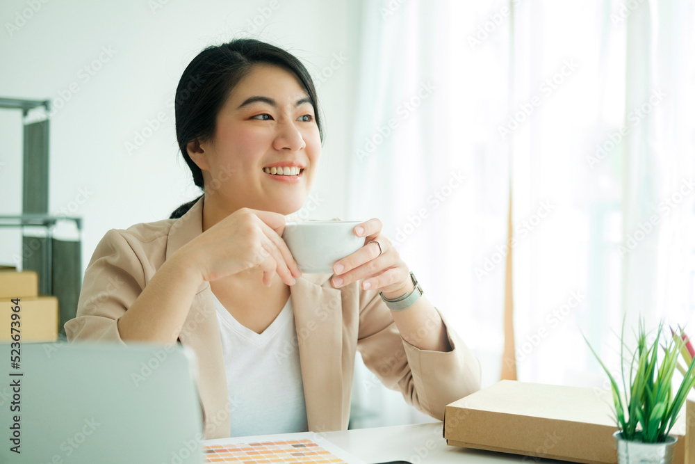 Happy young asian female freelan sit in online clothing store.. Happy young asian female freelan sit in online clothing store..