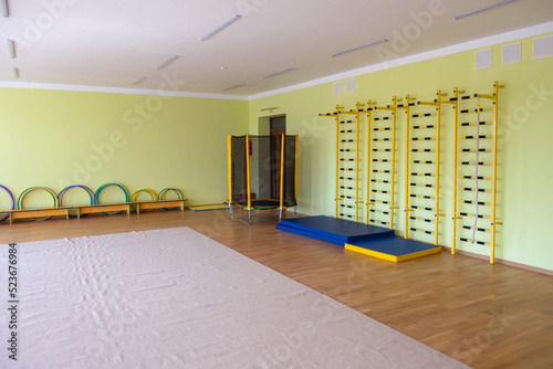 Lardge empty elementary school or kindergarten modern gym room with sport and recreational equipment photo