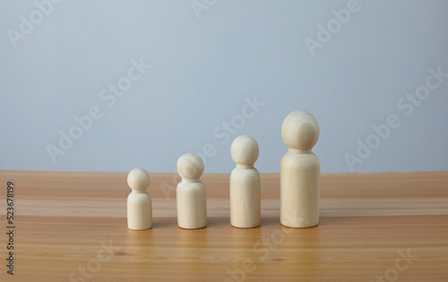 wooden dolls arranged in a row by height