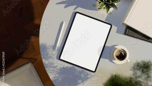 Digital tablet white screen mockup on modern white table. top view, workspace.