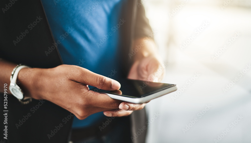 Businesswoman texting on phone, networking on social media and browsing internet at work. Closeup of the hands of a professional employee checking a text, scrolling an online app and reading messages