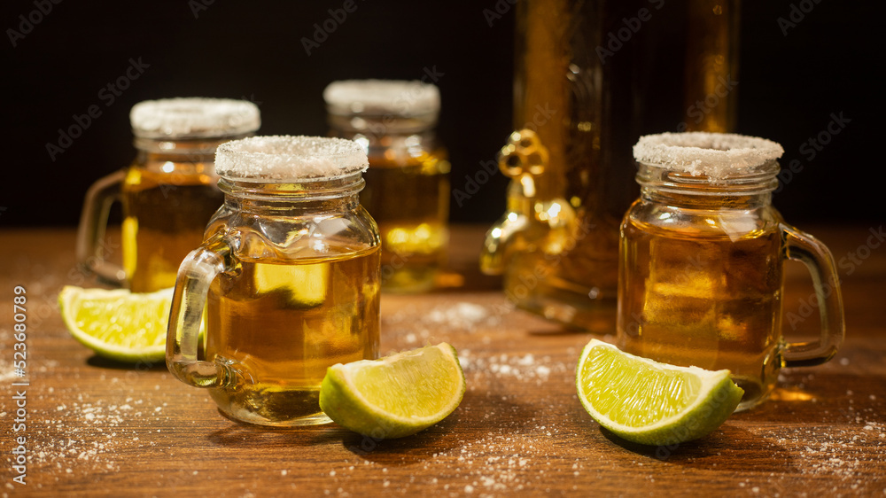 tequila shots served in jars with salt and lime on wooden table tequila shots served in jars with salt and lime on wooden table