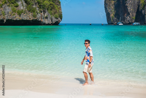 happy tourist man at Maya Bay beach on Phi Phi island, Krabi, Thailand. landmark, destination Southeast Asia Travel, vacation and holiday concept