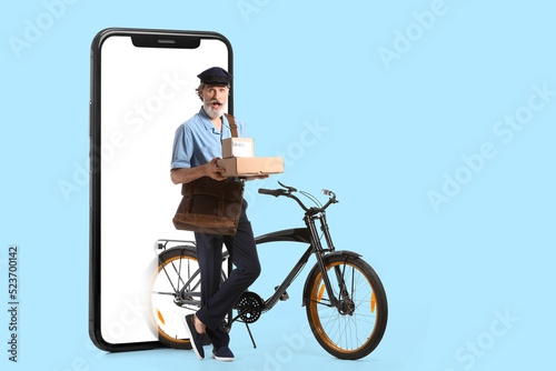 Senior postman with bicycle...