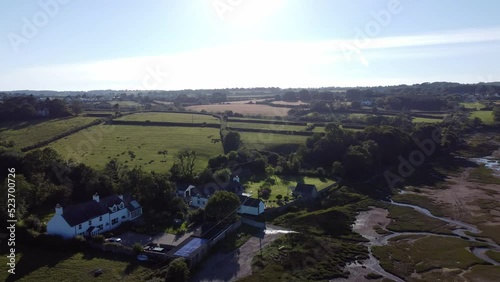 Aerial view across Traeth Coch Pentraeth farmland countryside with vacation cottages along salt marsh photo