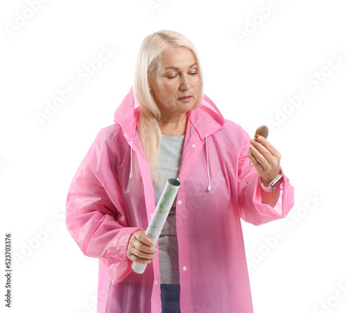 Mature woman in raincoat wi...