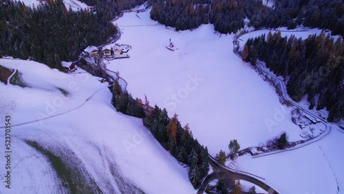 St John church in winter white valley in Dolomites mountain range, aerial photo