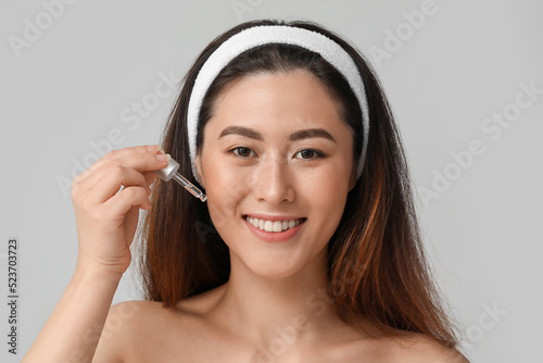 Young Asian woman with cosm...