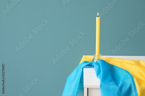 Burning candle and flag of ...