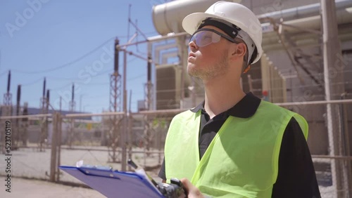 Energy distribution, transmission area.
Engineer making checks at work site.
