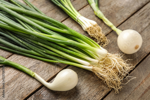 Green onion on wooden backg...