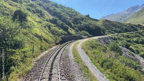 An old cog railroad runs over the mountains in Switzerland. The steam locomotive reminds of the old times. Pure nostalgia photo