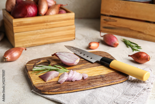 Wooden board with cut onion...