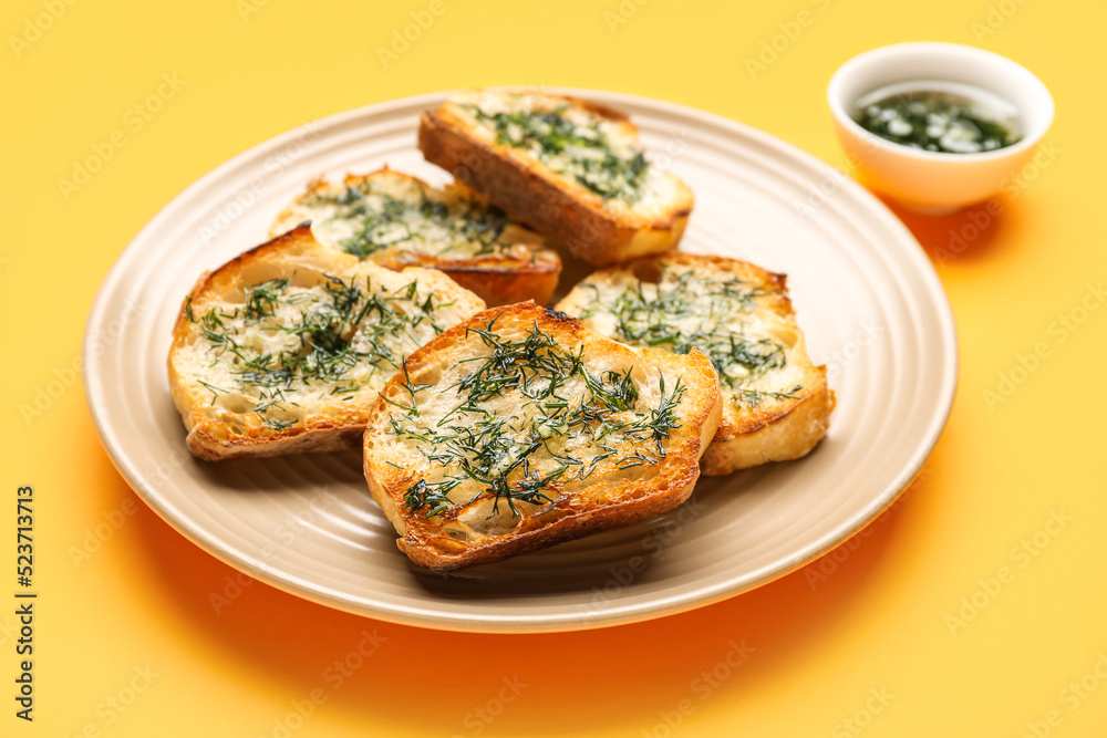 Plate of tasty toasts with garlic and dill on color background, closeup