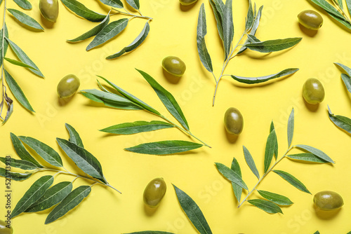 Green olives and leaves on ...