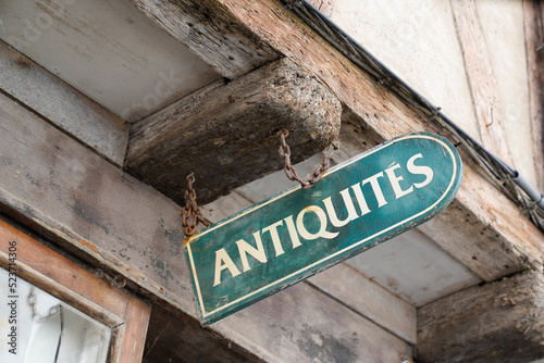 antiquites facade wall panel in city street with france text antiques in french antiquites translation means in english antiquities photo