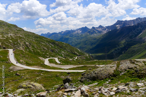 Scenic view of Bedretto Valley, Canton Ticino, with mountain pass road of Nufenen Pass on a sunny summer day. Photo taken July 3rd, 2022, Val Bedretto, Switzerland. photo