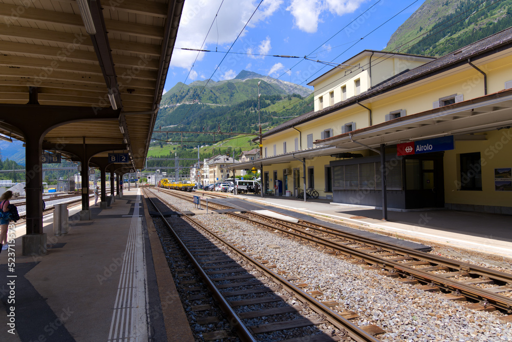 Platform at railway station of mountain village Airolo, Canton Ticino, on a sunny summer day. Photo taken July 3rd, 2022, Airolo, Switzerland.