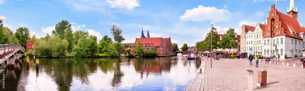 Panorama of the Trave shore in Lübeck with Salzspeicher, bridge and tradional buildings