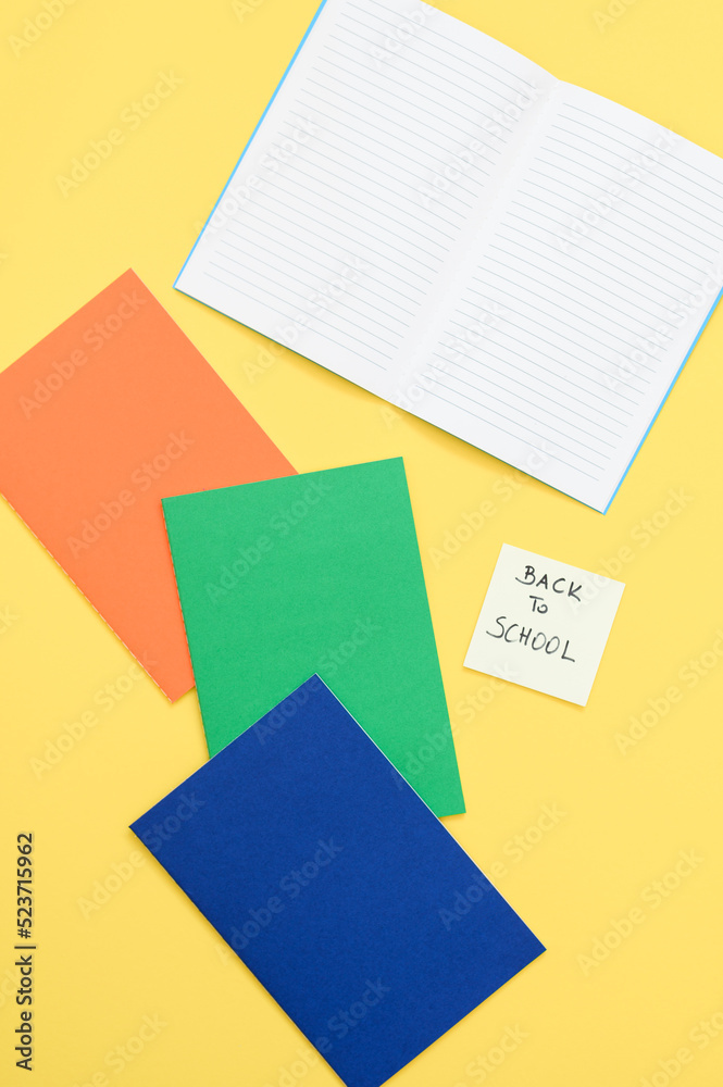 Text with back to school with notebook on background from above Text with back to school with notebook on background from above