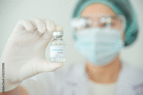 A doctor or scientist is holding a vaccine vial for monkeypox or clade.