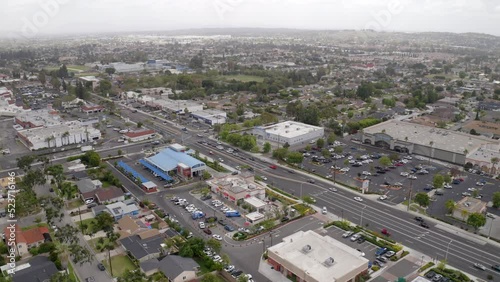 Aerial Lockdown Shot Of Cars Moving On Roads In Residential City Against Clear Sky - La Habra, California photo