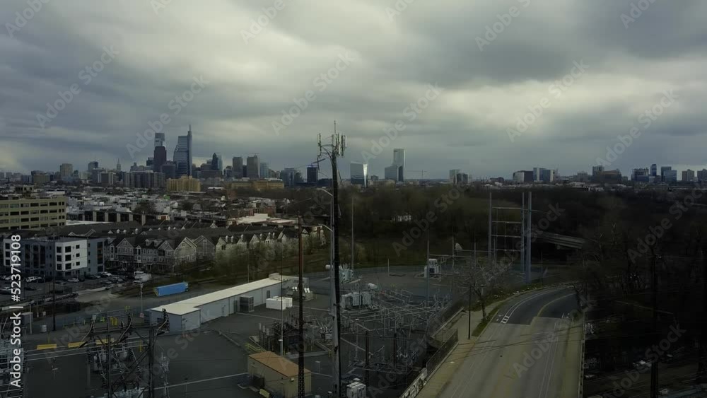 Aerial turn from highway roads to the skyline of downtown Philadelphia on an overcast day. Graffiti. Crows flying. Aerial turn from highway roads to the skyline of downtown Philadelphia on an overcast day. Graffiti. Crows flying.