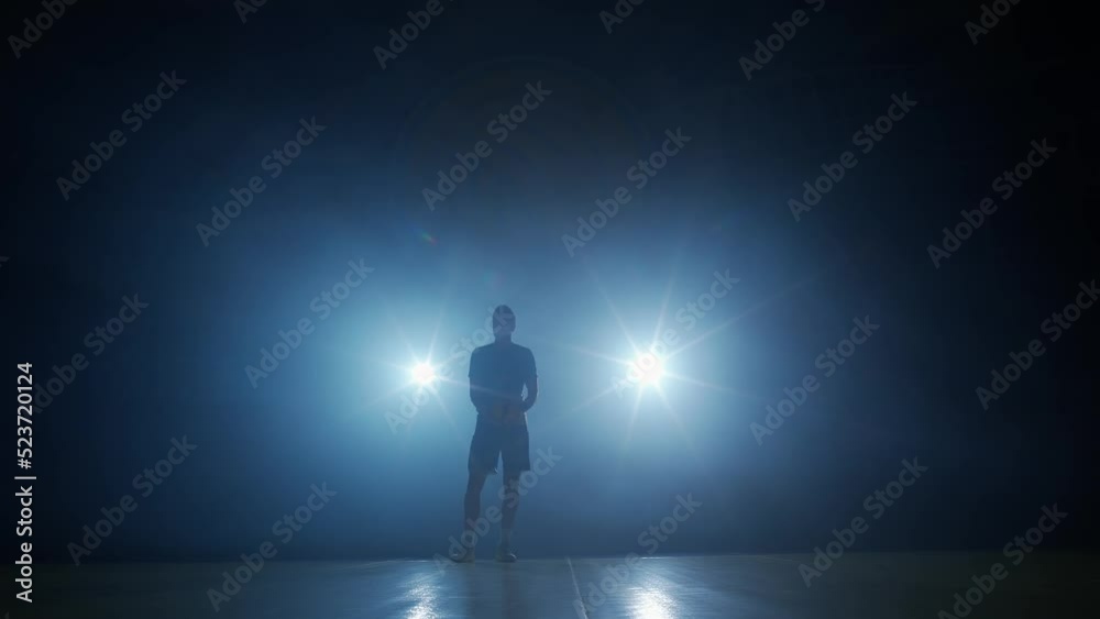 Sport lifestyle, anonymous man volleyball player throws the ball in his hands, contour lighting. Sport lifestyle, anonymous man volleyball player throws the ball in his hands, contour lighting.