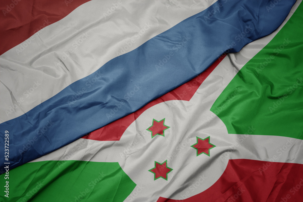 waving colorful flag of burundi and national flag of luxembourg.