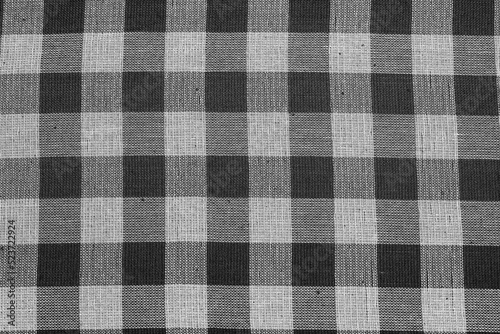 Textile background with checkered tablecloth, top view. Texture of natural linen fabric.