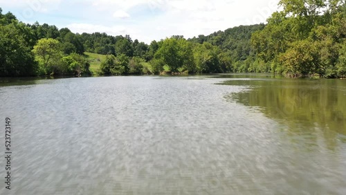 Aerial view flying low over river with sky reveal. photo