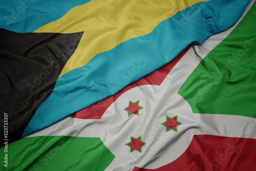 waving colorful flag of burundi and national flag of bahamas.