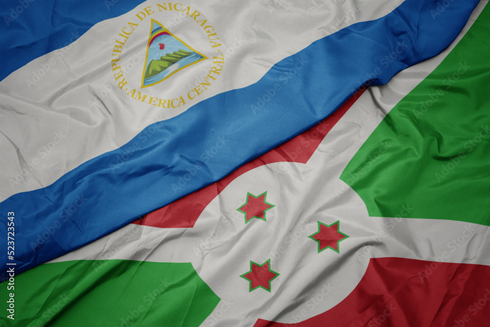 waving colorful flag of burundi and national flag of nicaragua. waving colorful flag of burundi and national flag of nicaragua.